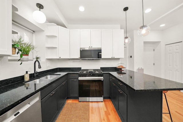 3406 W Medill Ave Unit 1, Chicago, IL 60647 - kitchen with appliances with stainless steel finishes, a sink, a peninsula, white cabinets, and recessed lighting