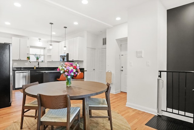 3406 W Medill Ave Unit 1, Chicago, IL 60647 - dining area with light wood-style floors, recessed lighting, and baseboards