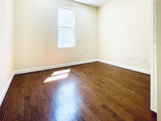 1426 N Central Park Ave, Chicago, IL 60651 - unfurnished room with dark wood-style floors and baseboards