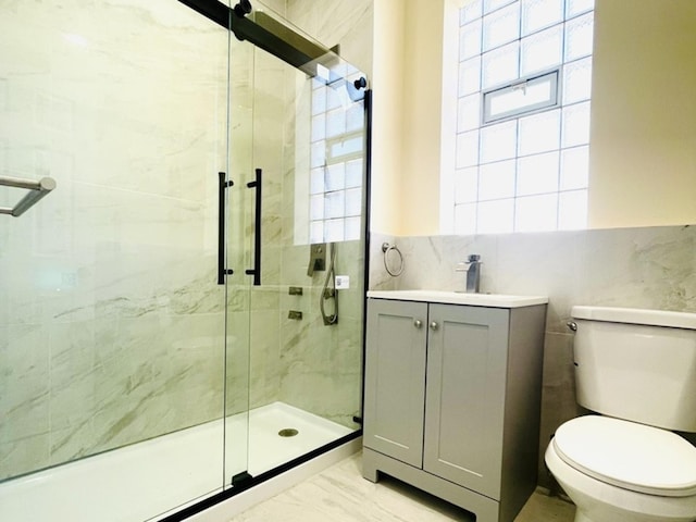 1426 N Central Park Ave, Chicago, IL 60651 - full bath with a stall shower, toilet, tile walls, marble look tile flooring, and vanity