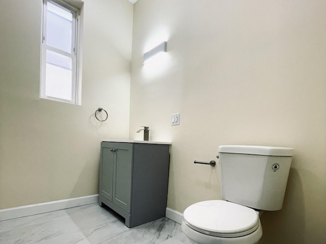 1426 N Central Park Ave, Chicago, IL 60651 - bathroom featuring marble look tile flooring, toilet, vanity, and baseboards