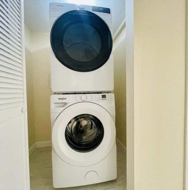 1426 N Central Park Ave, Chicago, IL 60651 - washroom with stacked washer / dryer, baseboards, and wood finished floors