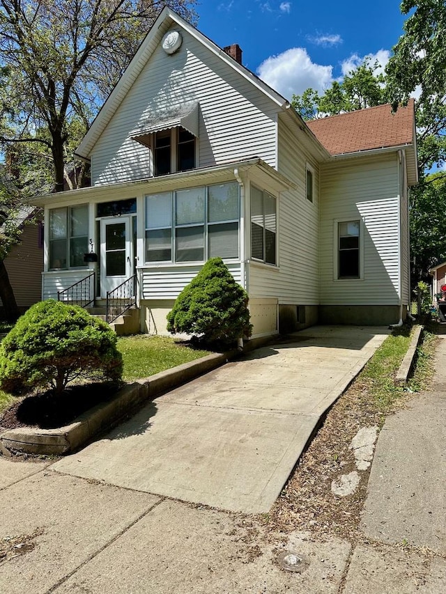 370 N St, Elgin, IL 60120 - back of house featuring a chimney, concrete driveway, and entry steps