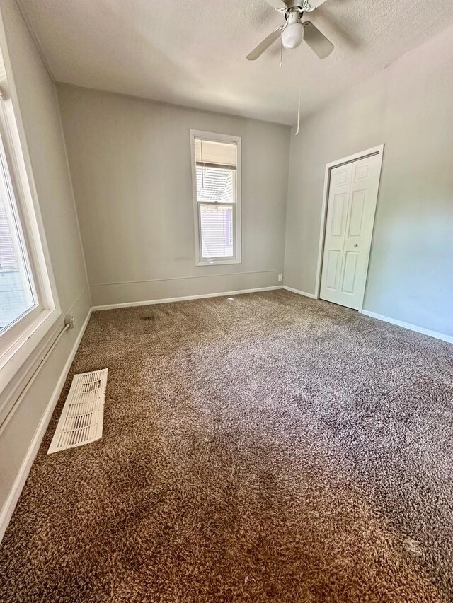 370 N St, Elgin, IL 60120 - carpeted spare room with a ceiling fan and a textured ceiling