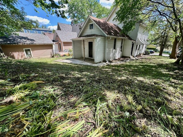 370 N St, Elgin, IL 60120 - rear view of house featuring a lawn