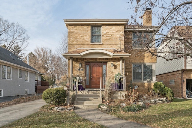 38 Northgate Rd, Riverside, IL 60546 - view of front of house featuring a chimney, brick siding, and a front yard