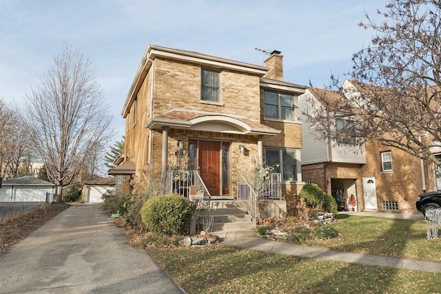 38 Northgate Rd, Riverside, IL 60546 - traditional-style house featuring a chimney, brick siding, a garage, an outdoor structure, and a front yard