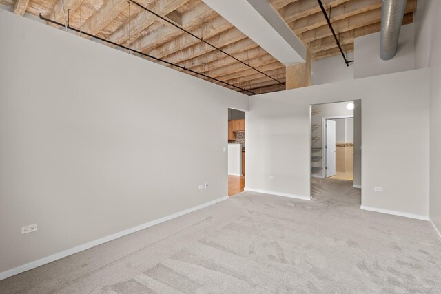 1645 W Ogden Ave Unit 304, Chicago, IL 60612 - carpeted spare room featuring baseboards and a high ceiling