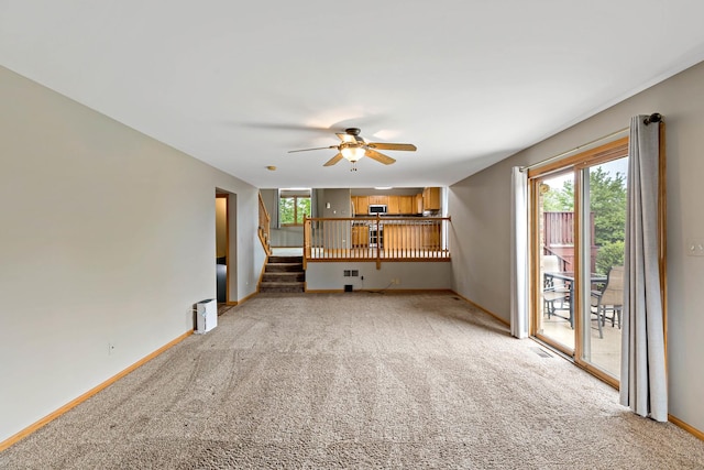 2807 Southwind Dr, New Lenox, IL 60451 - unfurnished living room featuring light carpet, ceiling fan, baseboards, and stairs