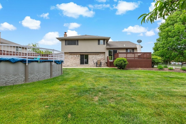 2807 Southwind Dr, New Lenox, IL 60451 - back of property with a deck, a covered pool, a chimney, a yard, and a patio area