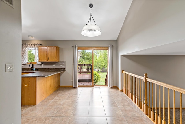 2807 Southwind Dr, New Lenox, IL 60451 - kitchen featuring a sink, dark countertops, decorative light fixtures, light tile patterned floors, and brown cabinetry