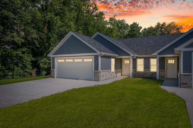 205 E Fairfield St, Fisher, IL 61843 - view of front facade featuring stone siding, a yard, a garage, and driveway