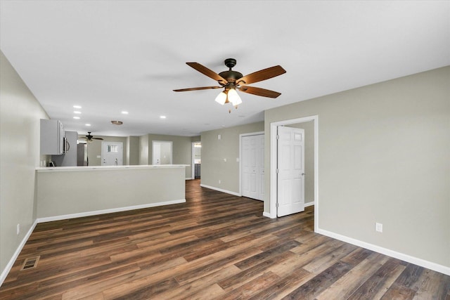 205 E Fairfield St, Fisher, IL 61843 - unfurnished living room featuring baseboards, dark wood finished floors, recessed lighting, and a ceiling fan