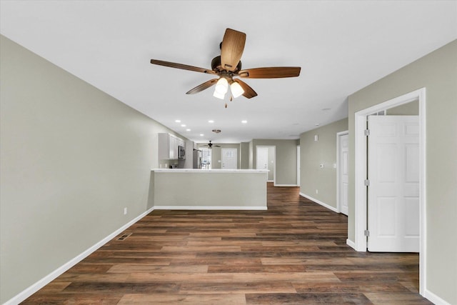 205 E Fairfield St, Fisher, IL 61843 - unfurnished living room featuring a ceiling fan, dark wood finished floors, baseboards, and recessed lighting