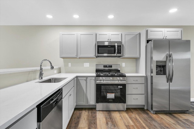 205 E Fairfield St, Fisher, IL 61843 - kitchen with stainless steel appliances, a sink, recessed lighting, dark wood-style floors, and gray cabinetry