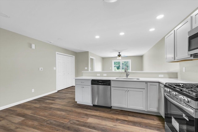 205 E Fairfield St, Fisher, IL 61843 - kitchen featuring appliances with stainless steel finishes, a sink, a peninsula, ceiling fan, and light countertops