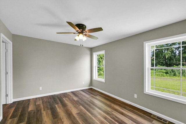 205 E Fairfield St, Fisher, IL 61843 - unfurnished room with baseboards, dark wood-style floors, and ceiling fan