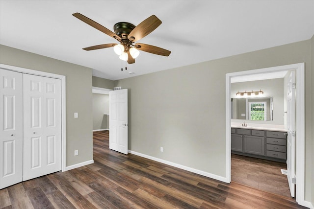 205 E Fairfield St, Fisher, IL 61843 - unfurnished bedroom featuring dark wood-style floors, a sink, a closet, and baseboards
