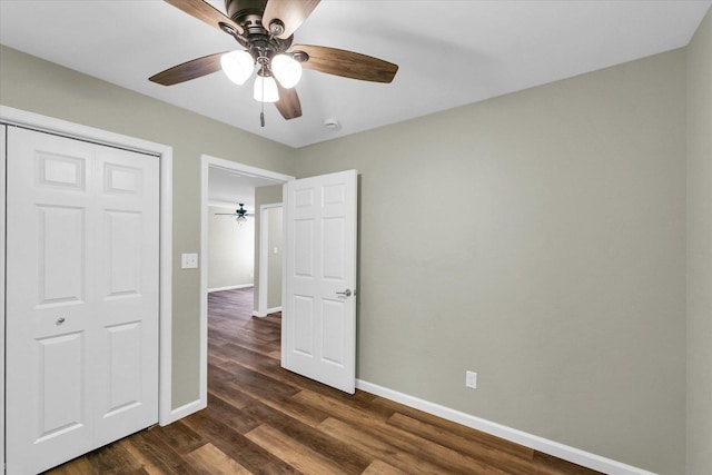 205 E Fairfield St, Fisher, IL 61843 - unfurnished bedroom featuring baseboards, dark wood-style floors, ceiling fan, and a closet