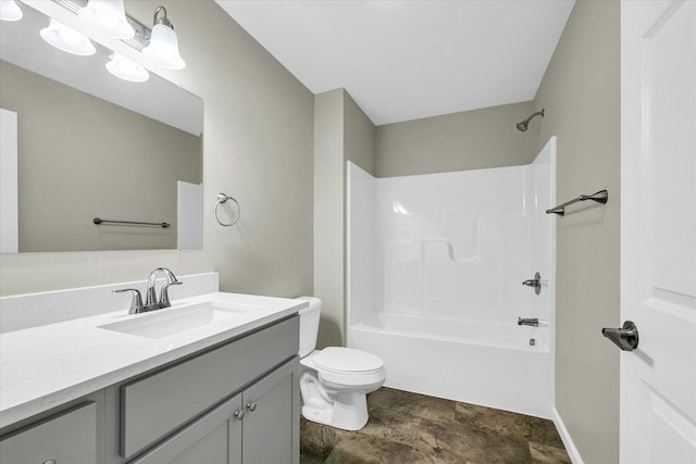 205 E Fairfield St, Fisher, IL 61843 - bathroom featuring vanity, toilet, bathtub / shower combination, stone finish floors, and baseboards
