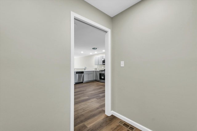 205 E Fairfield St, Fisher, IL 61843 - corridor with wood finished floors, baseboards, a sink, and recessed lighting