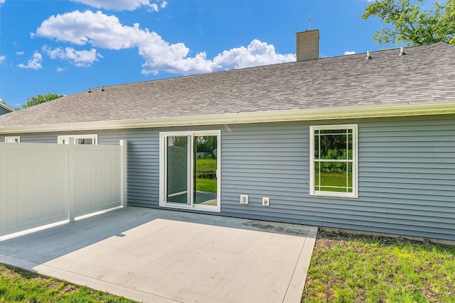 205 E Fairfield St, Fisher, IL 61843 - back of house with a patio, a chimney, and roof with shingles