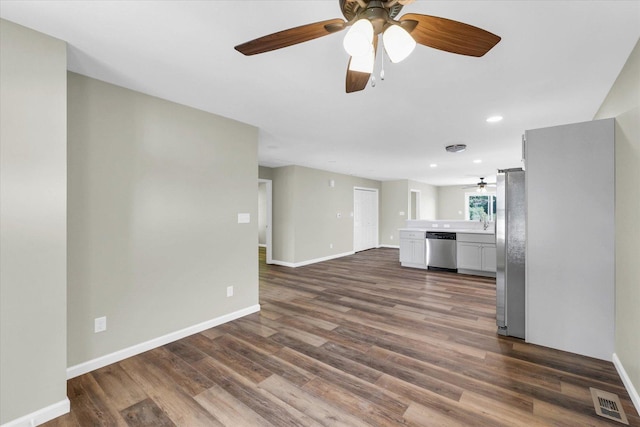 205 E Fairfield St, Fisher, IL 61843 - unfurnished living room featuring a ceiling fan, dark wood-style flooring, baseboards, and recessed lighting