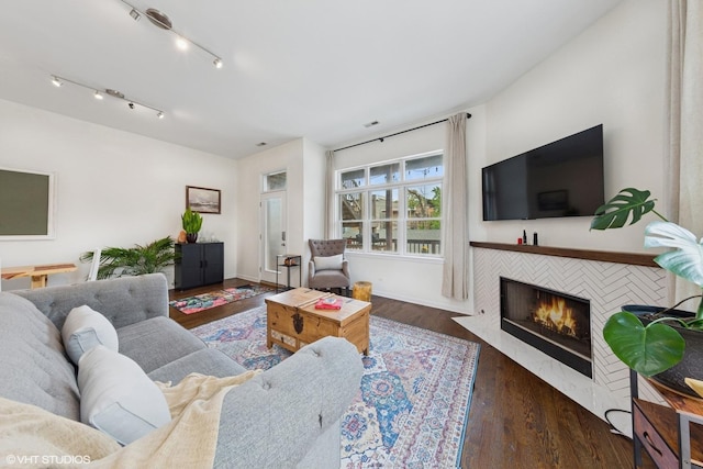 1615 N Oakley Ave Unit 2S, Chicago, IL 60647 - living area with a tile fireplace, wood finished floors, and baseboards