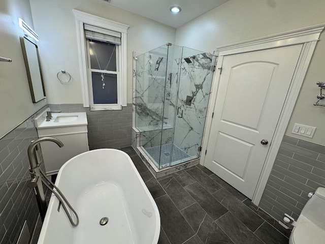 1304 N Wood St Unit 2, Chicago, IL 60622 - bathroom with tile walls, a wainscoted wall, a marble finish shower, a freestanding tub, and toilet
