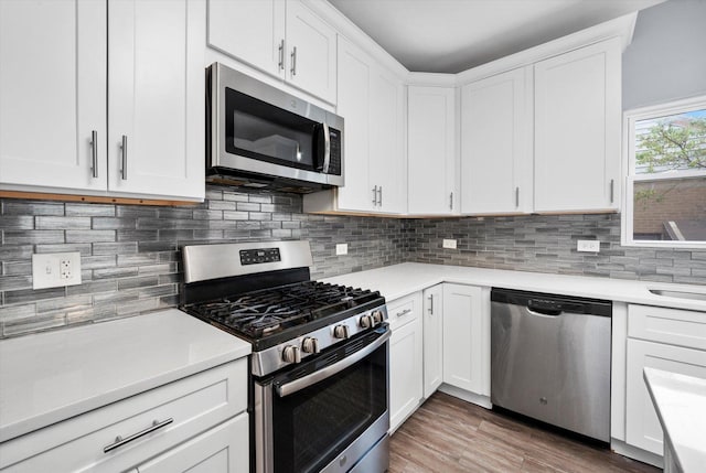 3534 Clarence Ave, Berwyn, IL 60402 - kitchen with stainless steel appliances, light countertops, white cabinets, and decorative backsplash