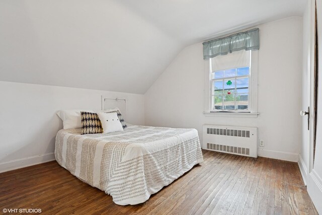 5748 N Lansing Ave, Chicago, IL 60646 - bedroom featuring radiator heating unit, wood-type flooring, lofted ceiling, and baseboards