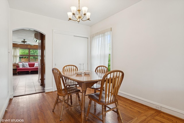 5748 N Lansing Ave, Chicago, IL 60646 - dining area with arched walkways, baseboards, hardwood / wood-style floors, and a chandelier