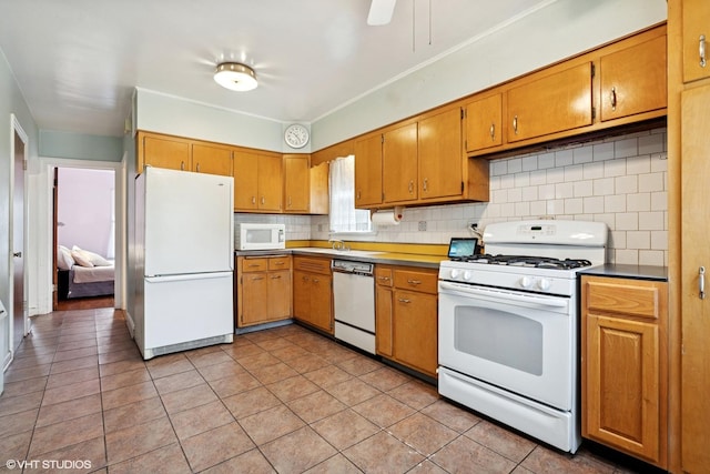 5748 N Lansing Ave, Chicago, IL 60646 - kitchen featuring white appliances, decorative backsplash, light tile patterned floors, and brown cabinets