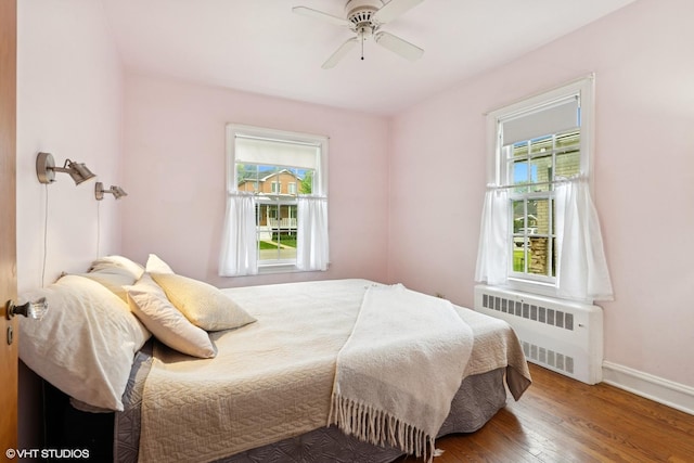 5748 N Lansing Ave, Chicago, IL 60646 - bedroom with radiator, wood finished floors, baseboards, and ceiling fan