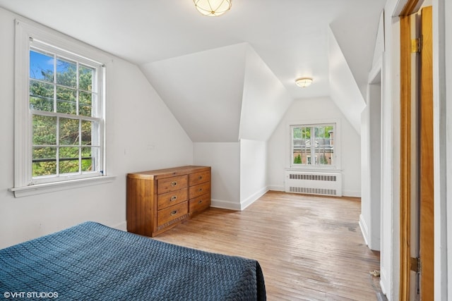 5748 N Lansing Ave, Chicago, IL 60646 - bedroom with radiator heating unit, light wood finished floors, baseboards, and lofted ceiling