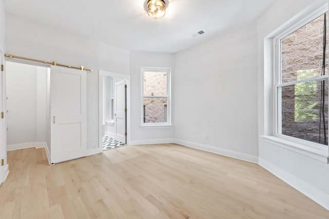 6233 S Woodlawn Ave Unit 2, Chicago, IL 60637 - unfurnished bedroom featuring light wood-style floors, baseboards, and ensuite bathroom