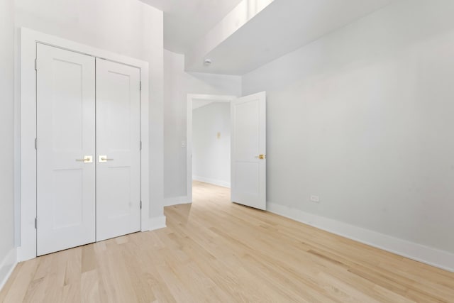 6233 S Woodlawn Ave Unit 2, Chicago, IL 60637 - unfurnished bedroom featuring light wood-type flooring, baseboards, and a closet