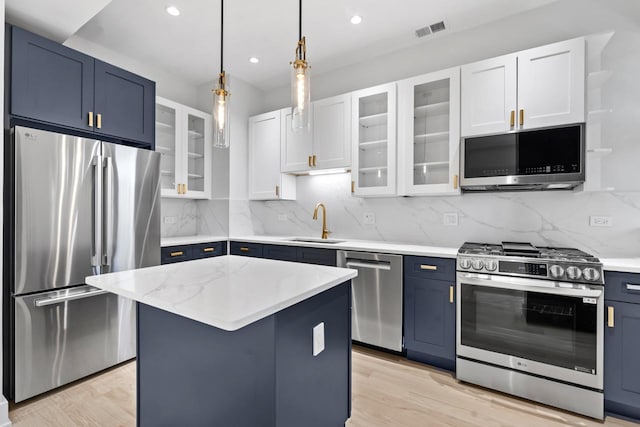 6233 S Woodlawn Ave Unit 2, Chicago, IL 60637 - kitchen featuring appliances with stainless steel finishes, blue cabinets, a sink, recessed lighting, and light wood-style flooring