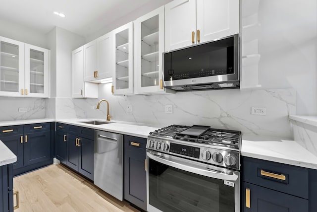 6233 S Woodlawn Ave Unit 2, Chicago, IL 60637 - kitchen featuring appliances with stainless steel finishes, blue cabinets, and white cabinets