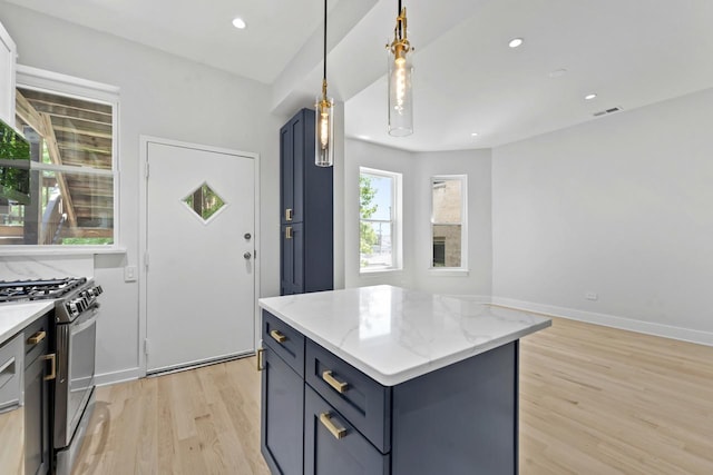 6233 S Woodlawn Ave Unit 2, Chicago, IL 60637 - kitchen with gas stove, light wood finished floors, a kitchen island, light stone countertops, and hanging light fixtures