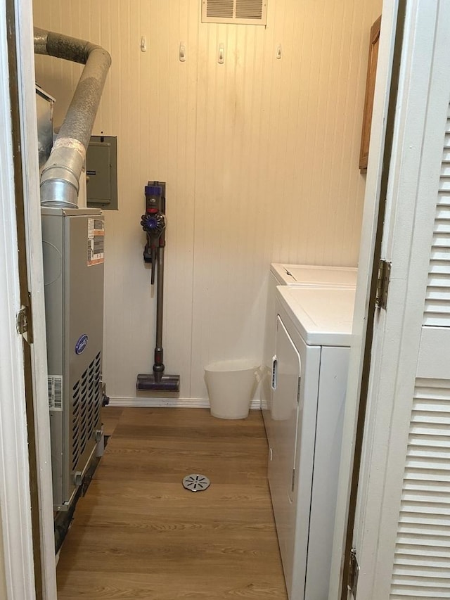 17612 71st Ct Unit 1N, Tinley Park, IL 60477 - laundry area with washer and clothes dryer, baseboards, light wood-style flooring, and electric panel