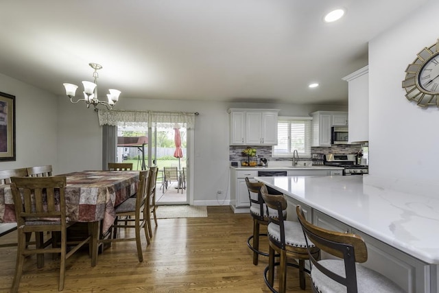 3106 Lebanon Ave, Zion, IL 60099 - dining area featuring wood finished floors, a chandelier, and recessed lighting