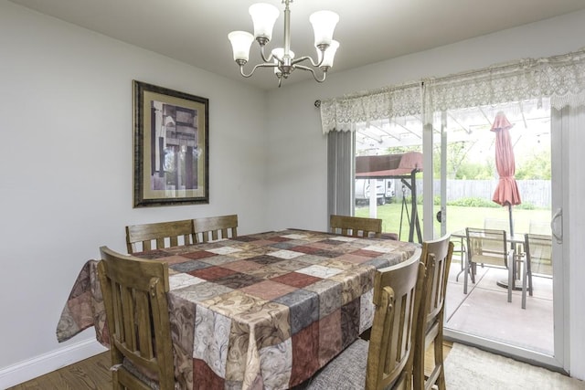 3106 Lebanon Ave, Zion, IL 60099 - dining area featuring a chandelier, light wood-style floors, and baseboards