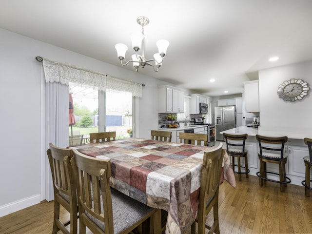 3106 Lebanon Ave, Zion, IL 60099 - dining space featuring a chandelier, wood finished floors, recessed lighting, and baseboards