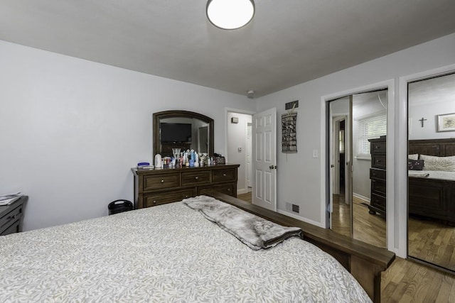 3106 Lebanon Ave, Zion, IL 60099 - bedroom with wood finished floors, multiple closets, and baseboards