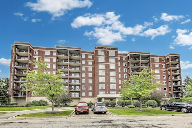 5555 N Cumberland Ave Unit 309, Chicago, IL 60656 - view of apartment building / complex featuring uncovered parking