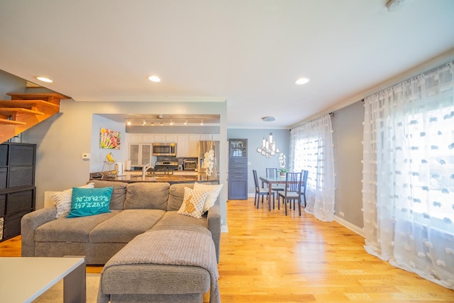 1352 Quaker Ln Unit 154C, Prospect Heights, IL 60070 - living room featuring light wood-style floors, crown molding, recessed lighting, baseboards, and a chandelier
