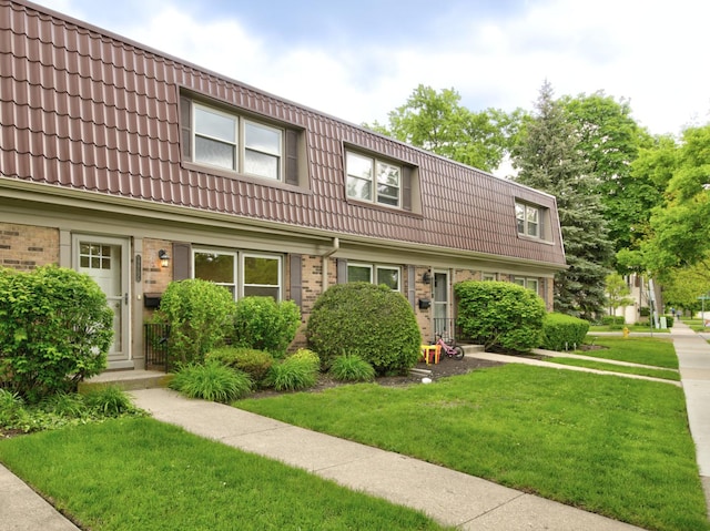 1770 Henley St Unit C, Glenview, IL 60025 - view of front facade with mansard roof, a tile roof, and a front lawn