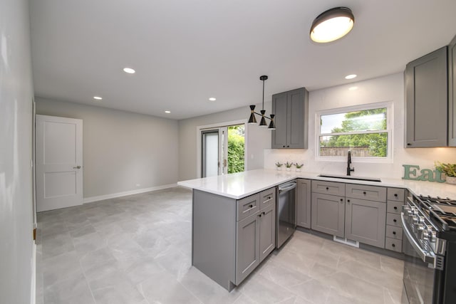 1770 Henley St Unit C, Glenview, IL 60025 - kitchen featuring a sink, gray cabinetry, appliances with stainless steel finishes, a peninsula, and light countertops
