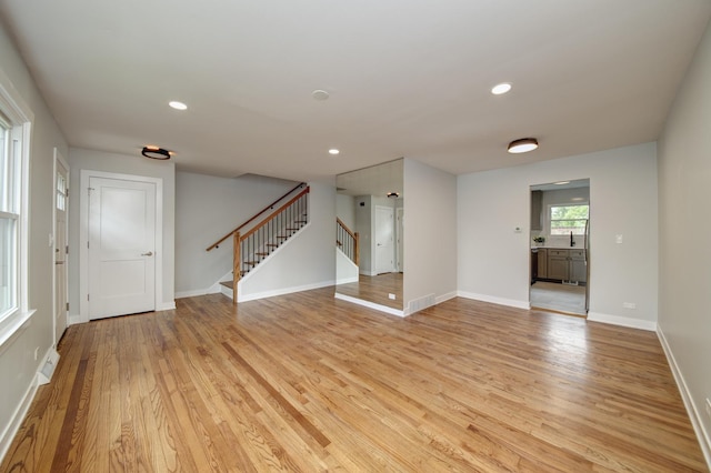 1770 Henley St Unit C, Glenview, IL 60025 - spare room featuring stairway, light wood-style flooring, baseboards, and recessed lighting